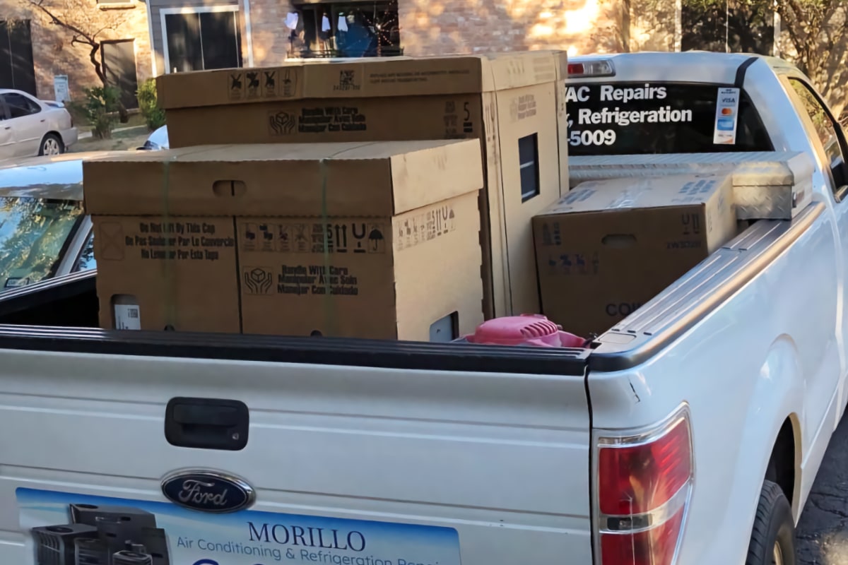 white Ford F-150 with Morillo company graphics and air conditioning units in truck bed